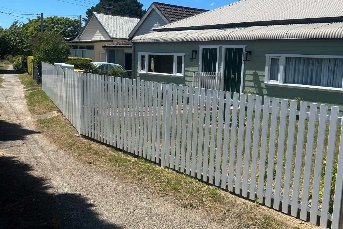 Contemporary white vertical slat front boundary fence