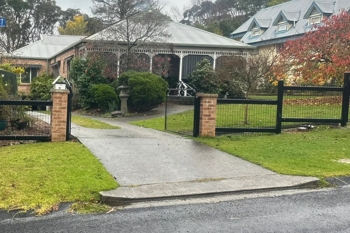 Black tubular steel and brick pillar front fencing