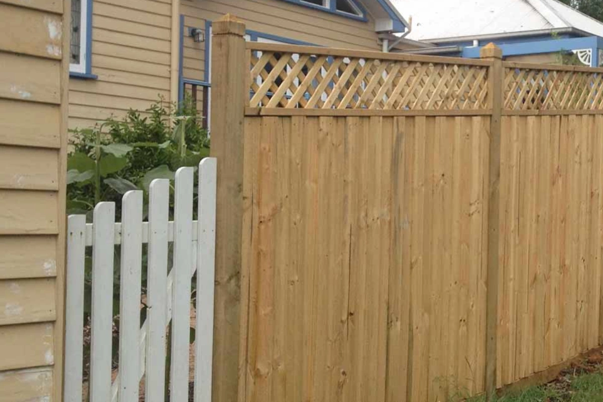 Timber paling privacy fence with diagonal lattice screen